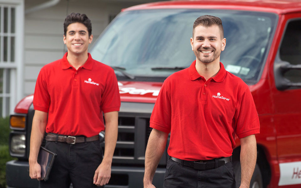 two men in front of a truck