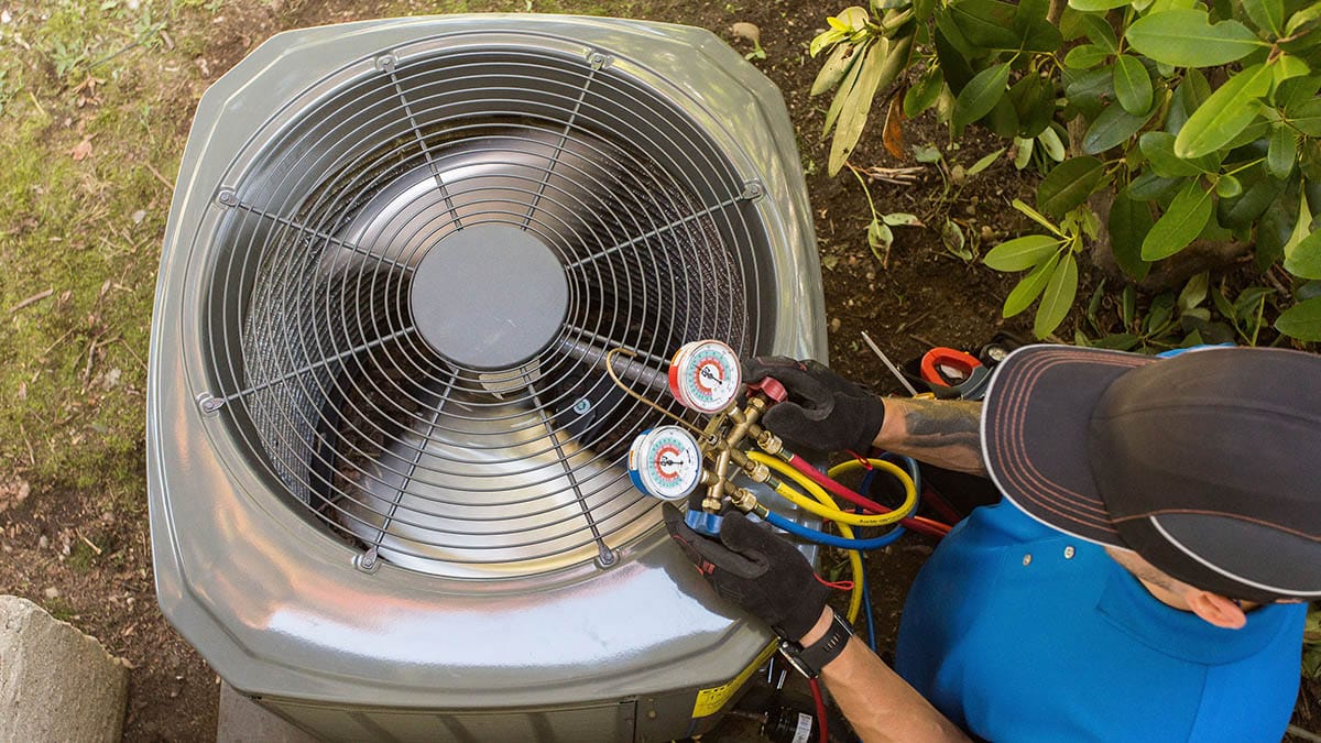 Dave Noonan all rights reserved © Modern Fotographic Photo from above of technician performing a maintenance test on an air conditioning unit