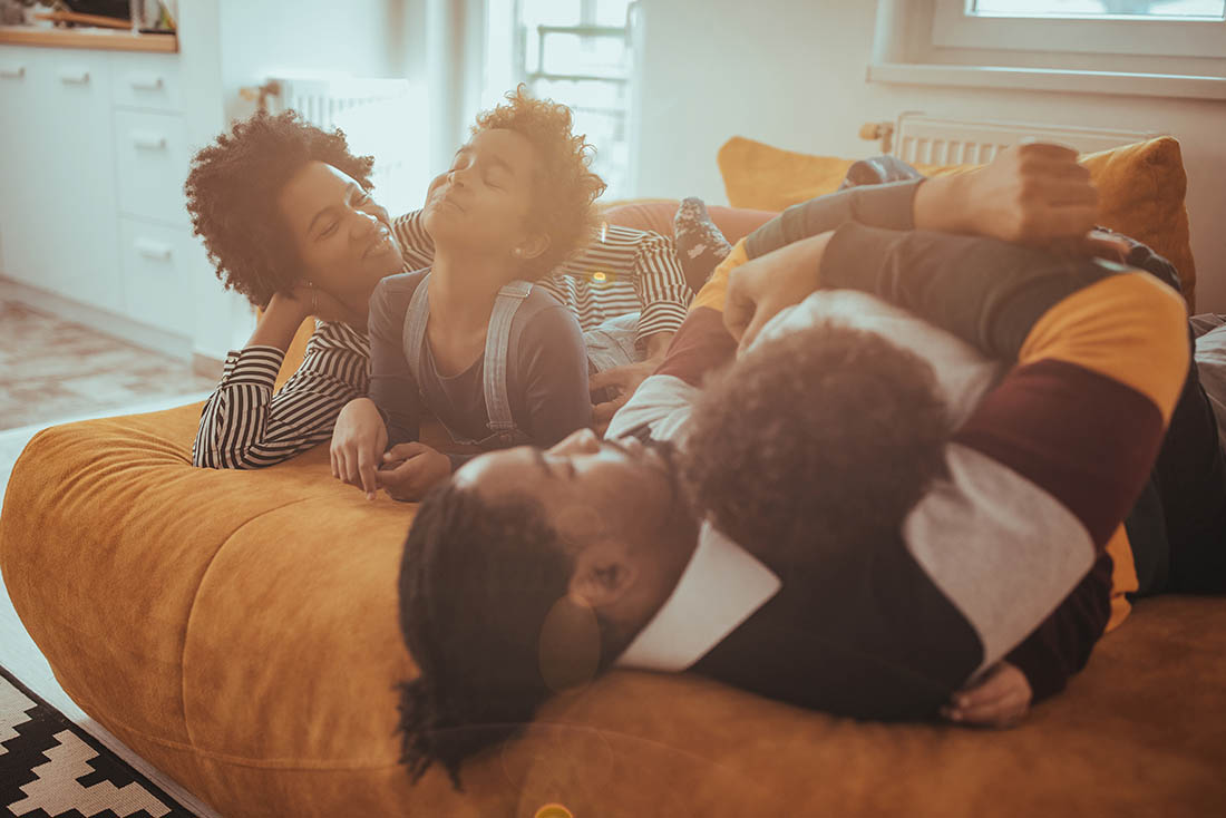 family cuddling on the couch
